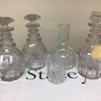 A pair of Victorian cut glass decanters with mushroom stoppers one other decanter and a glass carafe.