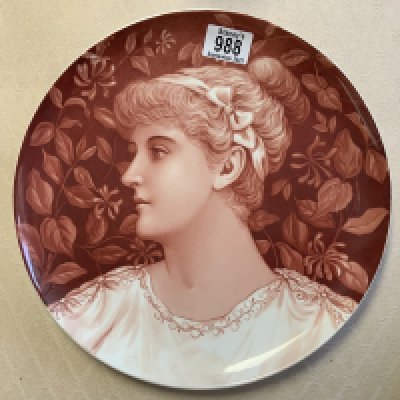 A ceramic wall charger with a hand painted pre-Raphaelite design of a lady. Impressed W to reverse. 30cm