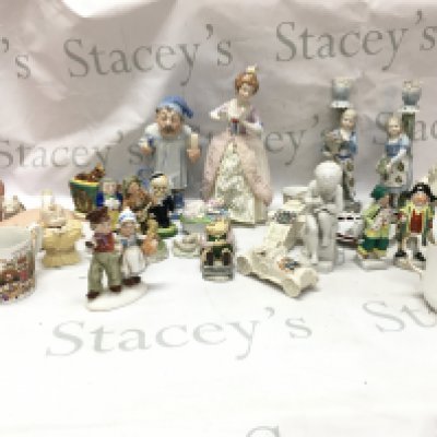 A collection of porcelain figures including German figures including a pair of couple candlestick figures, Southend on sea Carlton ware , GDR , Guinness Carltonware man with horse in cart. This lot cannot be posted