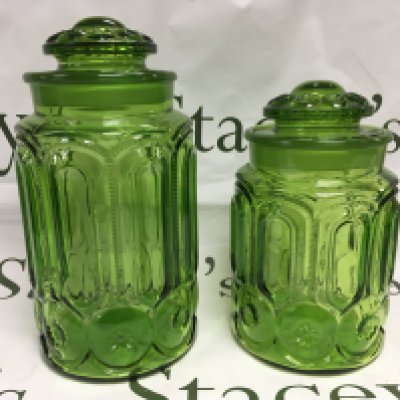 Two conforming garden glass jars and covers, approx heights 28cm and 23cm. Shipping category D.