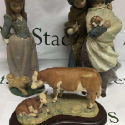 Two larger Lladro figures and a Border Fine Arts cow and calf on a wooden base. Largest figure approx 36.5cm. Shipping category D.