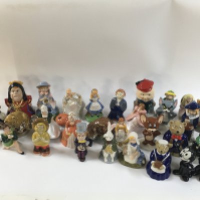 A collection of porcelain wade figures including Alice in wonderland figurines, Tom and Jerry, Felix the cat etc.