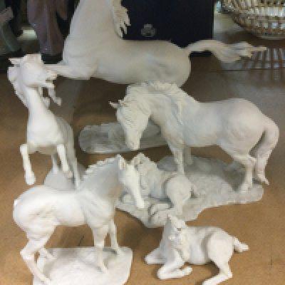 A collection of five Kaiser white glazed porcelain horse figures .