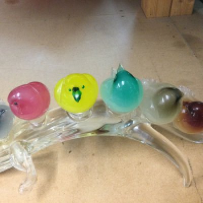A Murano glass sculpture in the form six birds of various colours On a branch.