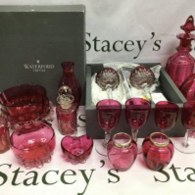 A collection of glassware comprising mainly cranberry examples, a boxed pair of Waterford Crystal drinking glasses etc. Shipping category D.