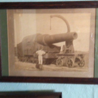 An intresting photograph of a late 19th century heavy cannon mounted on a Railway track a Marine photograph of an early steam ship and other antique photos and prints (10)