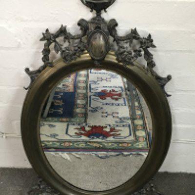 An ornate floral design oval mirror 45cm wide 82cm tall .this lot cannot be posted