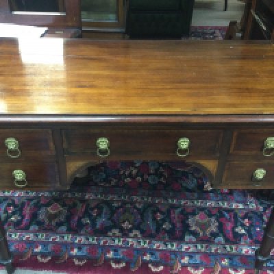 An inlaid mahogany desk fitted with drawers on turned legs , dimensions 104cm wide 50cm deep 75cm tall