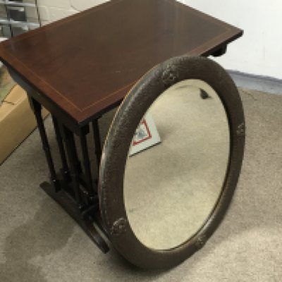 An oval oak framed wall mirror with a nest of mahogany tables. 54cm tall 52cm wide- NO RESERVE