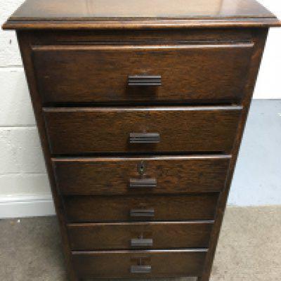 A tall oak flight of drawers. Approx height 98cm