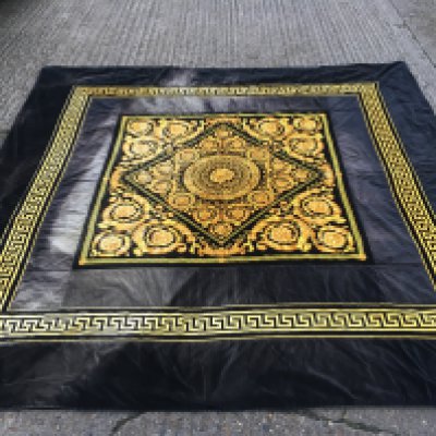 A Versace home collection black and gold floral design 100% polyester rug . Made in Italy. dimensions 258x258cm