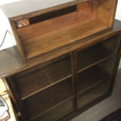 A mahogany cabinet with peach glass mirrored back top shelf, approx 110cm x 30cm x 130cm. Shipping category D.