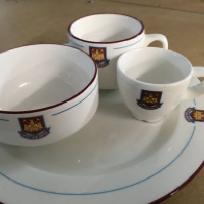 A Collection of westham ceramics comprising dinner plate tea cup coffees cup and sugar bowl .