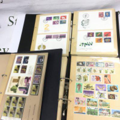 Thirteen albums of UK and world stamps and first day covers. Shipping category D.