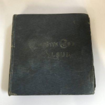 A box of loose cigarette cards and a box of 7 albums of cigarette cards