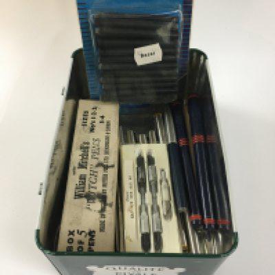 A tin box containing pens some Parker pen examples and ink refills.