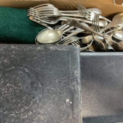 A box of various silver plate cutlery sets.