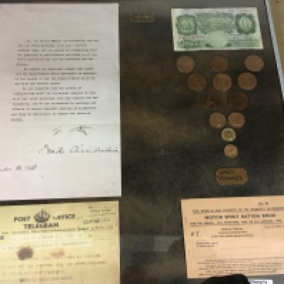 A framed collection of WW11 artefacts.