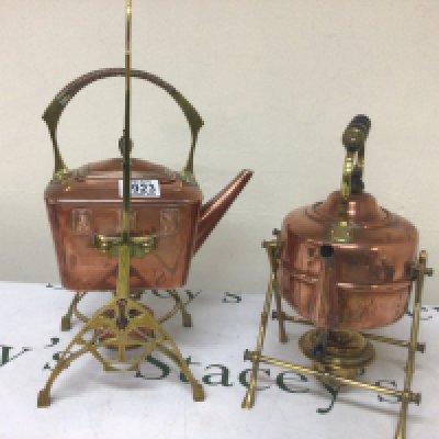 An Arts and Crafts style brass and copper spirit kettle and one other spirit kettle and stand (2)