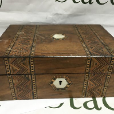 A walnut box containing watches.