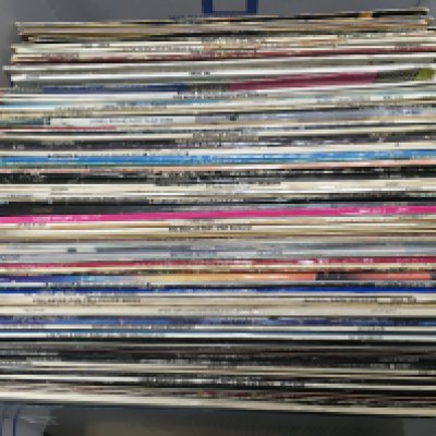 A box of LPs and 12" singles by various artists including Eddie Cochran, Santana, Chuck Berry and others. Shipping category D.