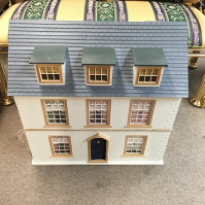 A large dolls house with lots of furniture and fittings included. 62cm wide 38cm deep 63cm tall. Postage D