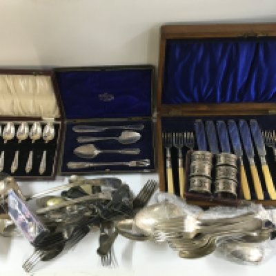 A collection of silver plated cutlery including knives, forks, napkin rings, tray etc