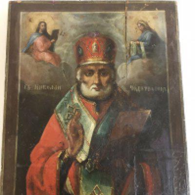 A 19th century Russian icon depicting Saint Nicholas of Myra , oil on wood, flanked by Christ and the mother of God with inscriptions 28.5cm wide 35cm tall approximately . Postage catC