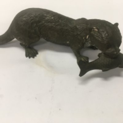 A cast bronze figure in the form of a otter with fish in mouth . 16 cm .