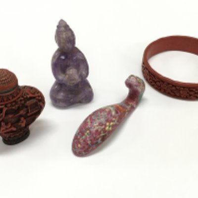 Chinese items including a red snuff bottle , carved gemstone Buddha figure , ceramic dragon head, red bangle style bracelet with a carved floral pattern. This lot cannot be posted