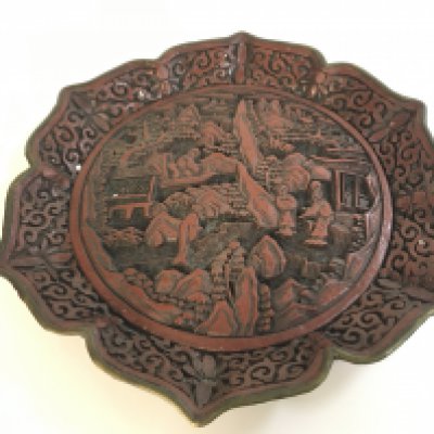 A Chinese red cinnabar plate signed with a six character mark at the base . 22cm wide Approx . Postage cat b