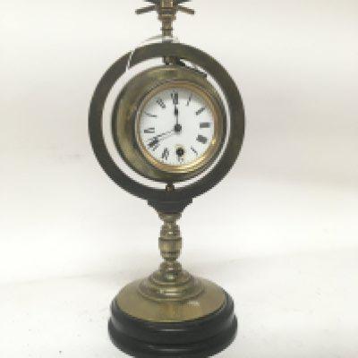 A Victorian brass clock barometer with a revolving Spherical ball. No Reserve. Height 33cm. With key