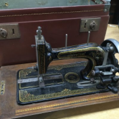 A hand crank cased Universal sewing machine