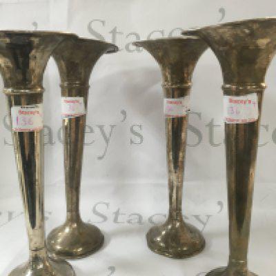 Four silver plated vases, which each measure 30.5cm high and 9.5cm wide.