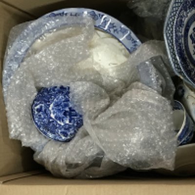 Two boxes containing a quantity of mixed blue and white ceramics. NO RESERVE