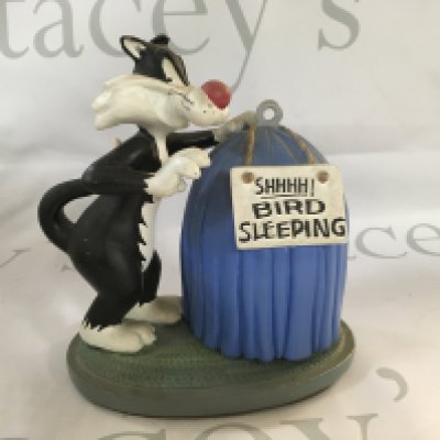 Box of figurines including Disney, Looney Tunes, dream dragons, a small snow globe and other items.