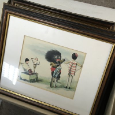 A collection of vintage framed golly prints