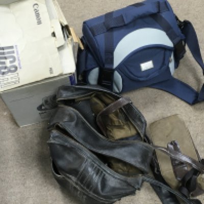 A collection of vintage camera equipment including a Canon 8mm video camcorder, Samsung 8mm