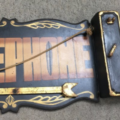 A Laurel and Hardy telephone sign with a gold coloured arrow that is adjustable/able to rotate. It measures around 106cm wide.
