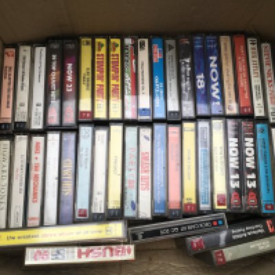 Two boxes of audio cassettes by various artists including Queen, Peter Gabriel and others.