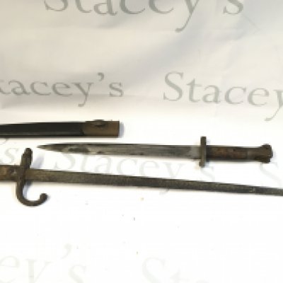 Two bayonets including an English bayonet marked EFD, scabbard damaged. 45cm long and a French bayonet, 61cm long.
