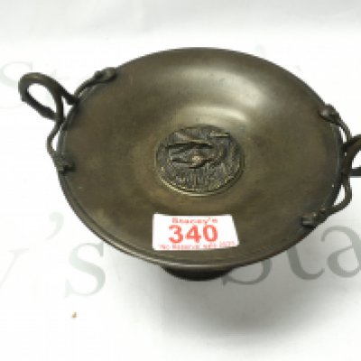 A bronzed dish with a raised bird decoration in the middle. 19cm by 10cm Postage B