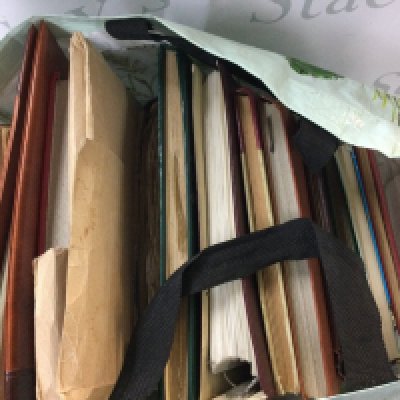 A collection of stamp albums from multiple different countries in the world.