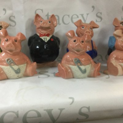 A collection of antique pig money boxes from 1980s NatWest. Includes all 5 of the pigs and 2 extra small pigs. Also includes a vintage license plate and an antique brick.