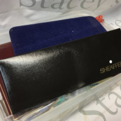 A cased Sheaffer pen, loose used stamps, simulated pearl necklace, collection of necklaces, pen knives