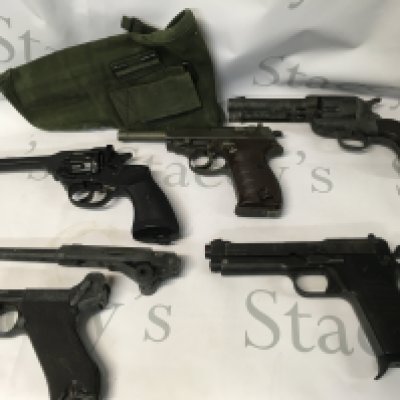 A collection of replica guns such as some starter gun toys, a Mark 4 revolver from 1923 in UK, a Maroshin P38 model gun made in Japan, another revolver, and a broken gun. Some in need of restoration.