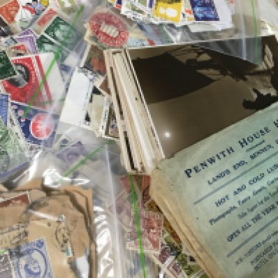 A collection of postcards and stamps including the Great Britain stamp album. Also there is a complete cutlery set made by Winers.