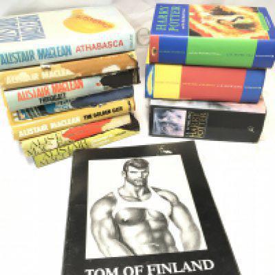 A collection of Alistar Maclean books including Athabasca, The Golden Gate etc. Harry Potter books and Tom of Finland retrospective