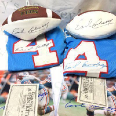A collection of items signed by Earl Campbell former professional American football player including Two limited Edition signed jersey shirts, two photographs and two footballs.