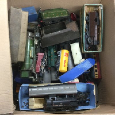 A box of model railway items comprising locos and accessories, various gauges.